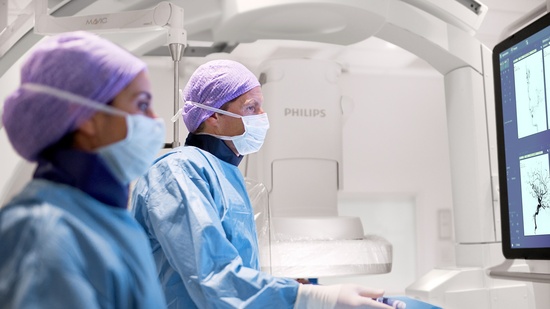 An interventional physician assesses a stroke patient on the Philips Azurion image-guided therapy platform